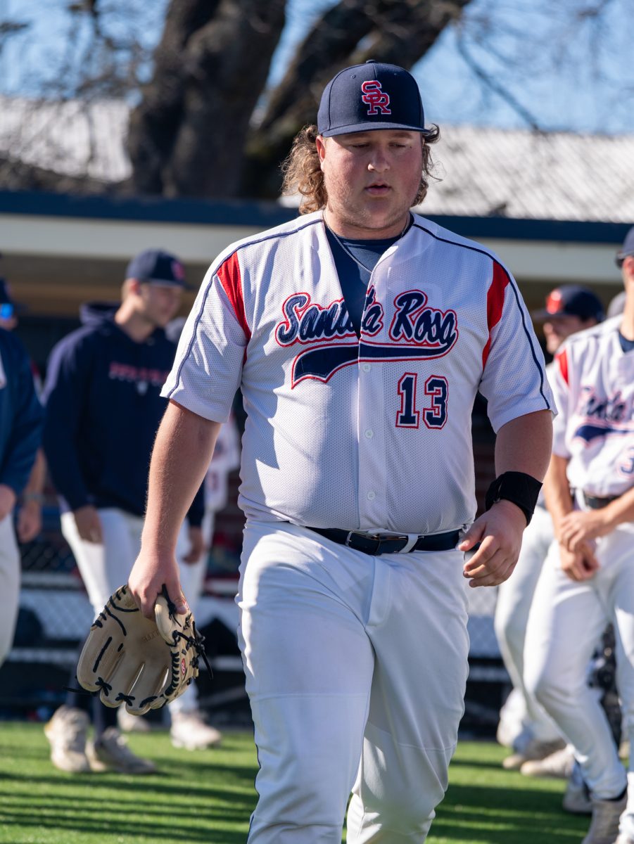 Freshman Luke Dillon walks from the dugout to the mound as he prepares to start as pitcher for the Bear Cubs in the game against West Valley College at home, Jan. 28, 2025.