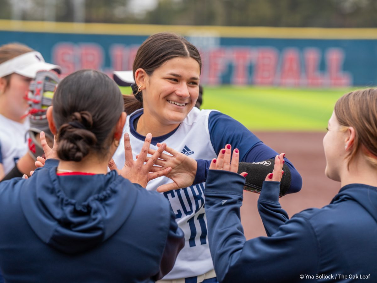 Starting pitcher Mia Avila smiles as she reaches the end of the lineup after her name is announced overhead ahead of the game against Modesto on Saturday, March 15, 2025 in Santa Rosa.