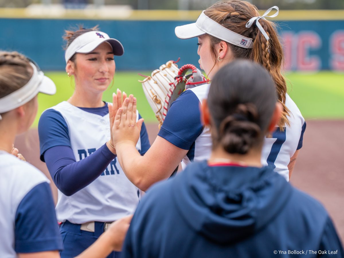 Sophomore first baseman Sofia Uricoechea taps Kylee Bauman's hands as she makes her way through the lineup ahead of the game against Modesto on Saturday, March 15, 2025 in Santa Rosa.