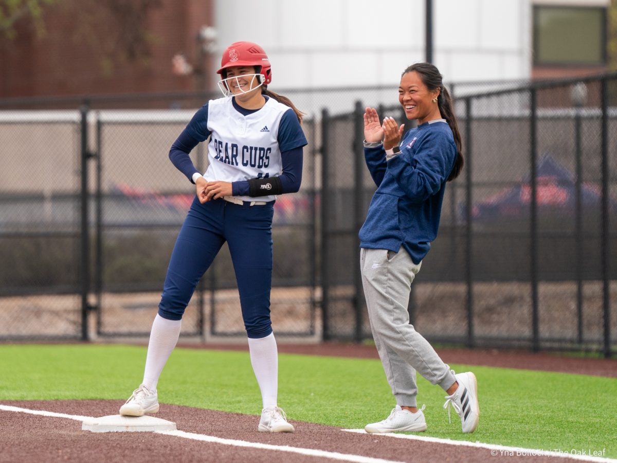 Freshman pitcher Mia Avila reaches first base and celebrates with assistant coach Anna Zoia-Beuscher during the game against Modesto on Saturday, March 15, 2025 in Santa Rosa.