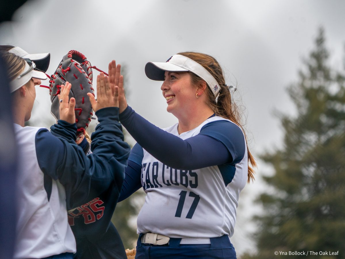 Sophomore first baseman Sofia Uricoechea celebrates near the dugout after a clutch catch at the fences of the opposing dugout during the game against Modesto on Saturday, March 15, 2025 in Santa Rosa.