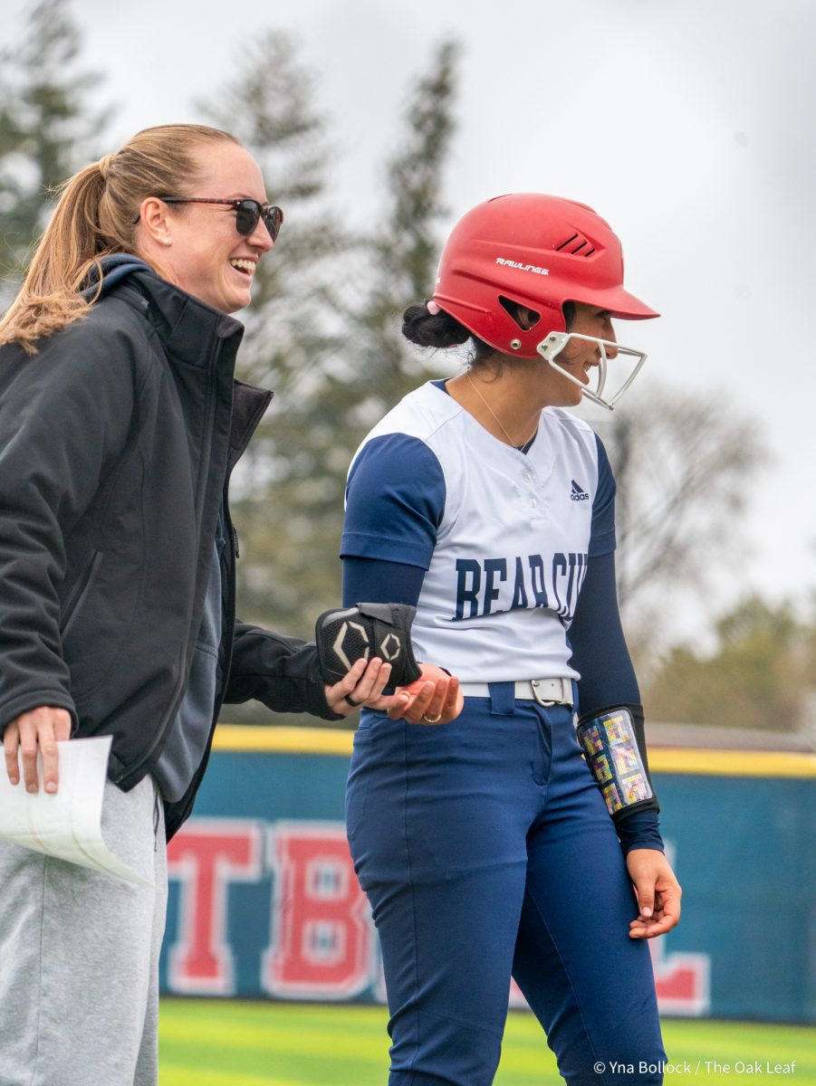 Head coach Madison Green takes freshman center fielder Mira Olvera's gear after yet another triple in game two against Modesto on Saturday, March 15, 2025 in Santa Rosa.