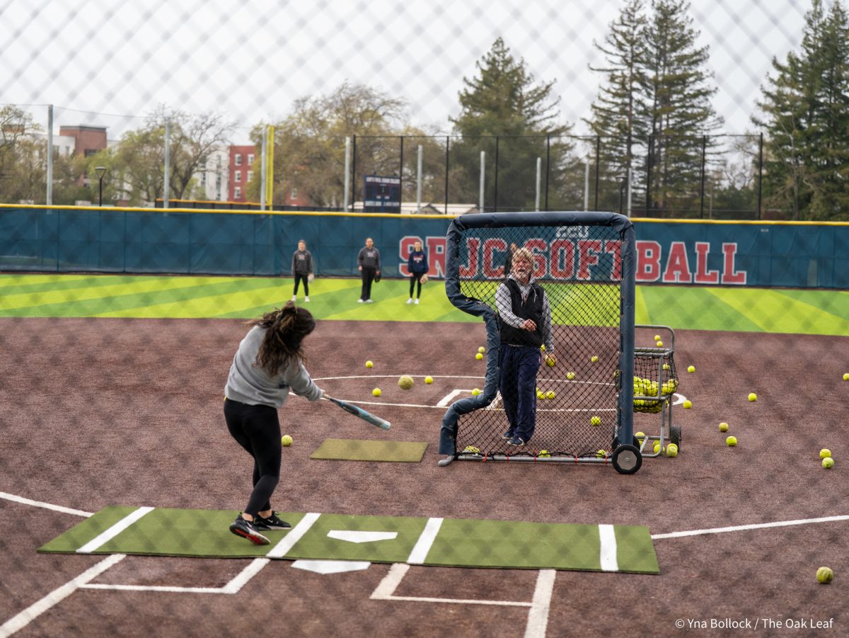 Alum Cayla Nixon takes soft toss pitches from assistant coach Doug Beuscher during the SRJC Softball Alumni Home Run Derby on Saturday, March 15, 2025 in Santa Rosa.
