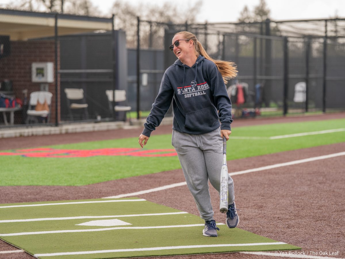 Head coach Madison Green laughs as she steps up to the plate during the SRJC Softball Alumni Home Run Derby on Saturday, March 15, 2025 in Santa Rosa.