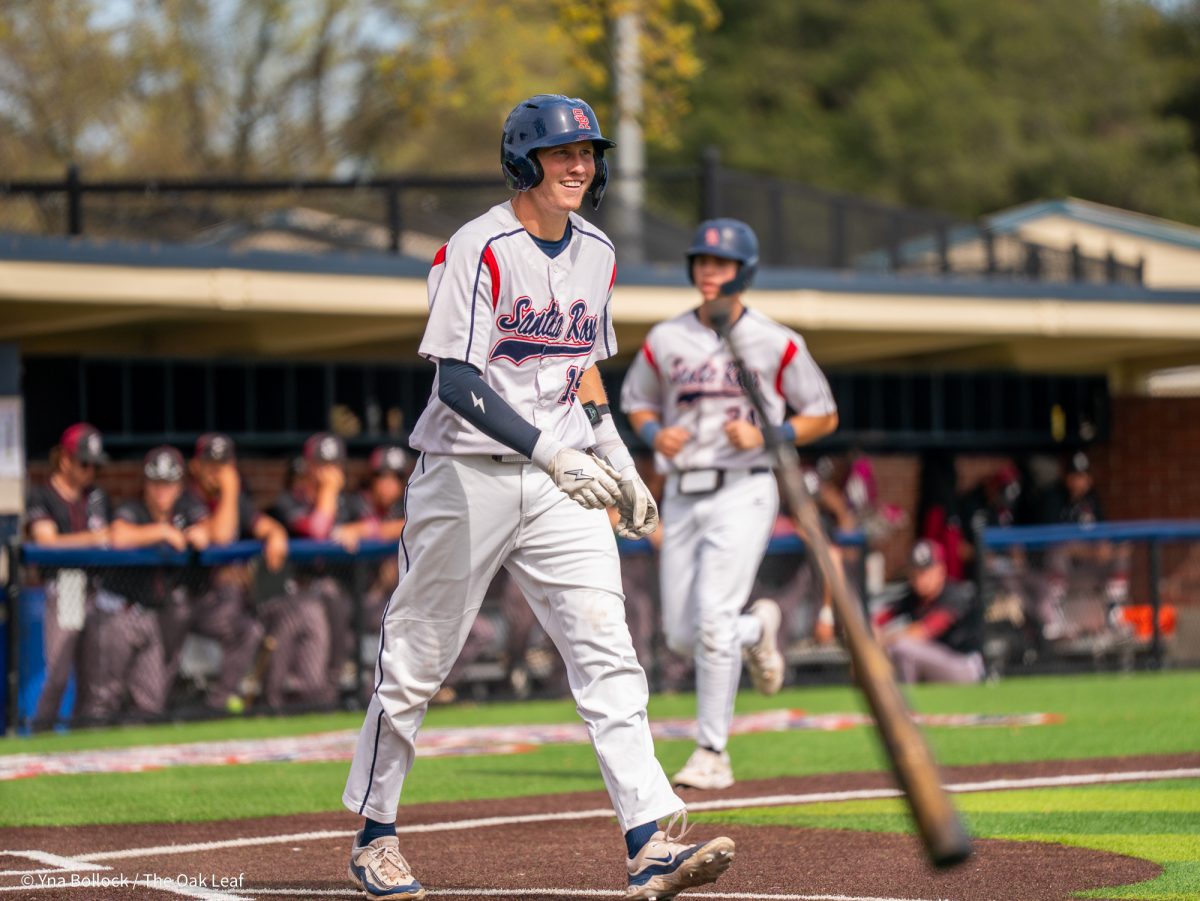 Freshman shortstop Brett Neidlinger walks with a smile to first base after being hit by a pitch for an RBI against Sierra on Thursday, March 20, 2025 in Santa Rosa.
