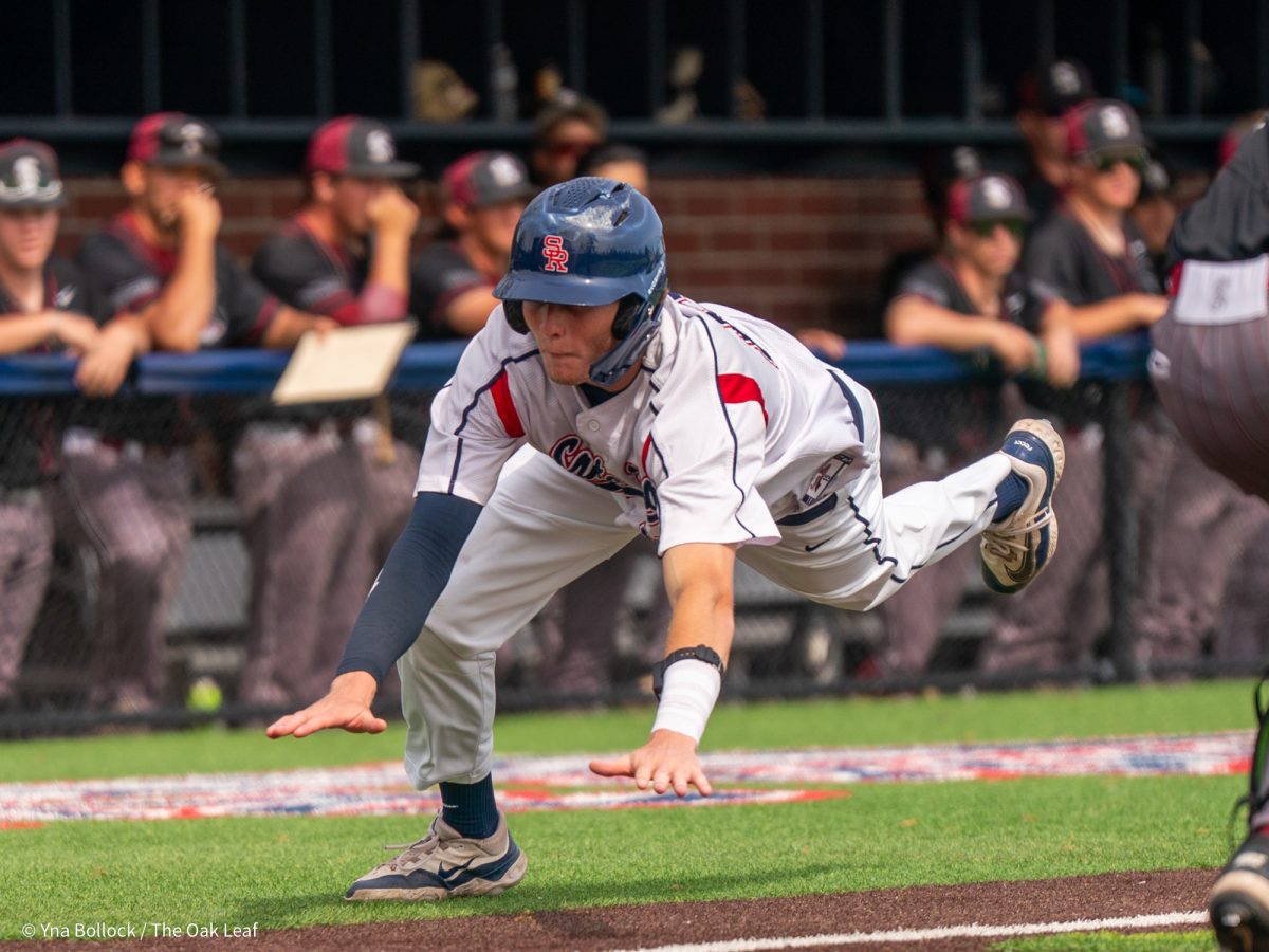 Freshman shortstop Brett Neidlinger gets ready to dive home in the bottom of the fourth against Sierra on Thursday, March 20, 2025 in Santa Rosa.