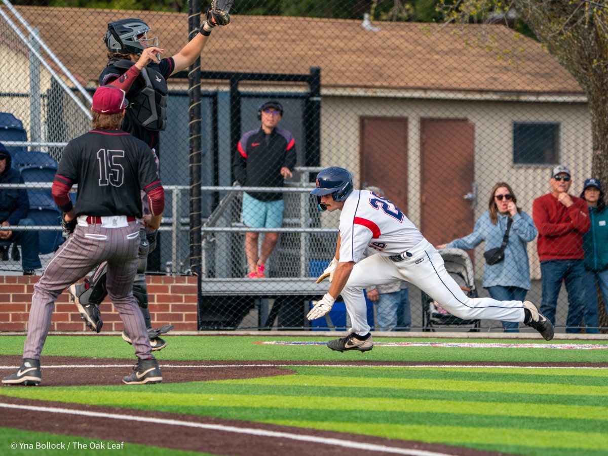 Sophomore pinch runner Shane Moran slide home safe on the throw in the bottom of the eleventh for the win against Sierra on Thursday, March 20, 2025 in Santa Rosa.