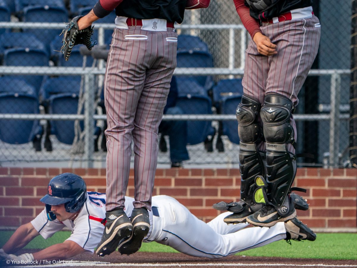 Sophomore pinch runner Shane Moran slide home safe on the throw in the bottom of the eleventh for the win against Sierra on Thursday, March 20, 2025 in Santa Rosa.