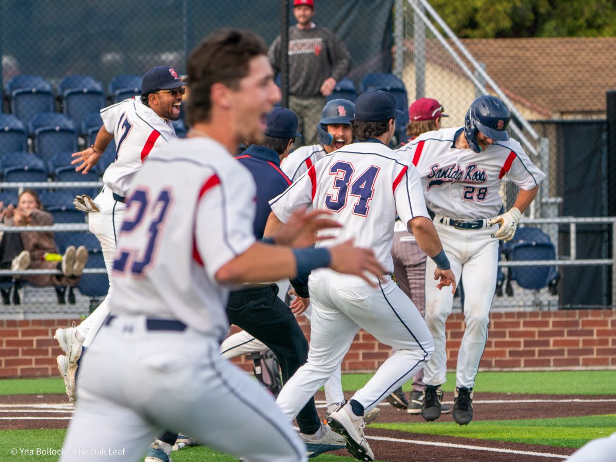 The Bear Cubs clear the dugout as sophomore Shane Moran (#28) is scooped up at home plate to celebrate the win against Sierra on Thursday, March 20, 2025 in Santa Rosa.