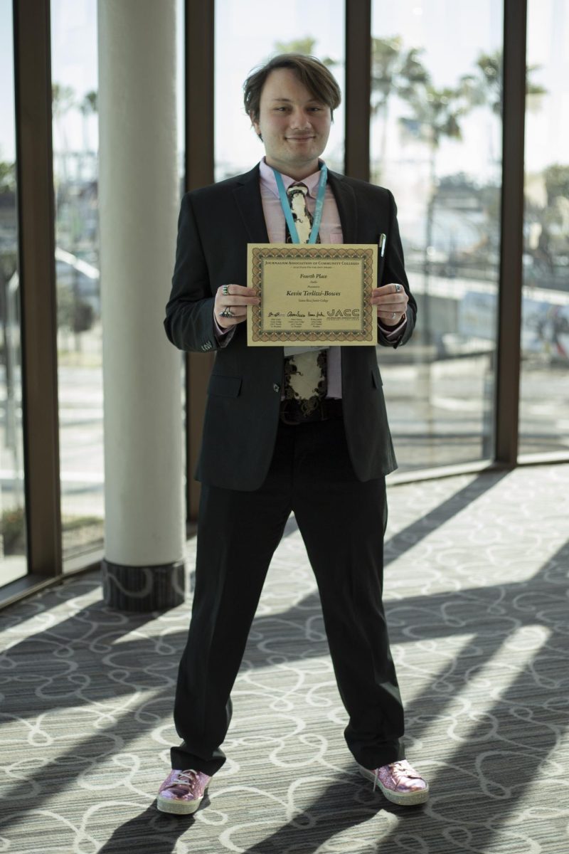 The Oak Leaf's podcast editor, Kevin Terlizzi-Bowes shows off his award as his outfit steals the show at the ACP Spring National Media Conference on Saturday, March 8, 2025 in Long Beach, California.