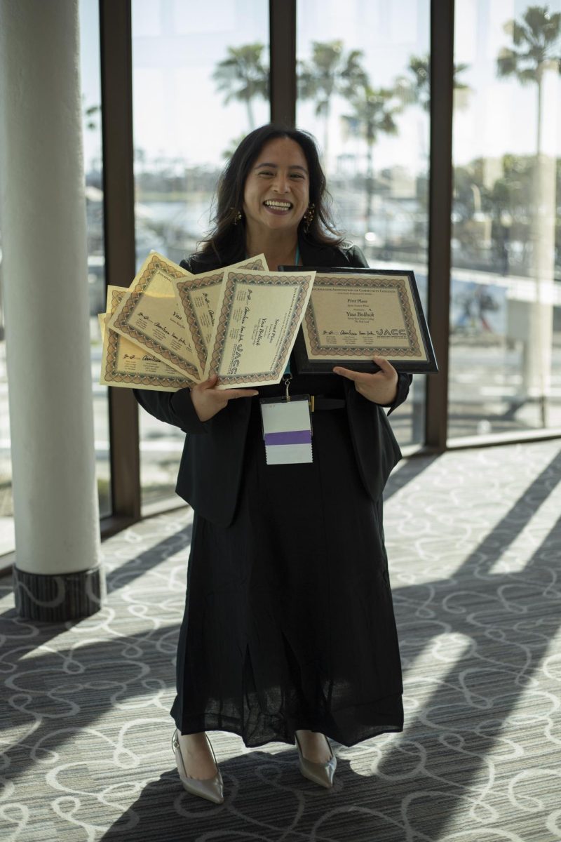 The Oak Leaf's beloved photographer Yna Bollock proudly shows off her handful of awards at the ACP Spring National Media Conference on Saturday, March 8, 2025 in Long Beach, California.