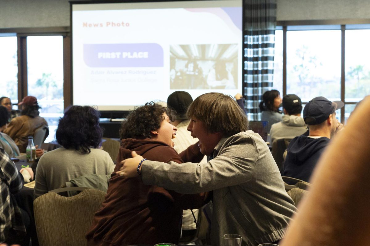 The Oak Leaf's photographers, Adair Alvarez Rodriguez and Nathan Kaito Morris embraces each other and celebrates loudly as Rodriguez places first for "On the Spot News Photo" at the ACP Spring National Media Conference on Saturday, March 8, 2025 in Long Beach, California.