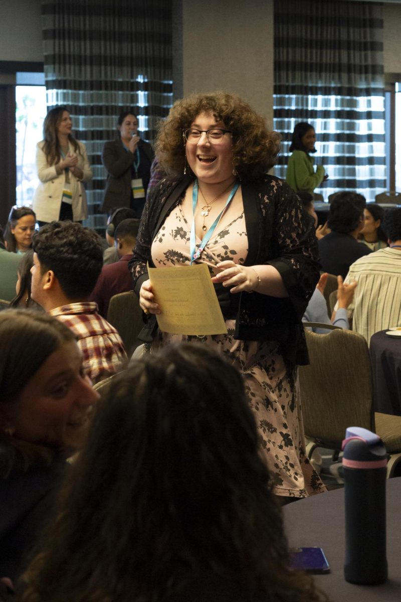 The Oak Leaf's Natalie Emanuele is all smiles as she walks back with her in the spot award at the ACP Spring National Media Conference on Saturday, March 8, 2025 in Long Beach, California.
