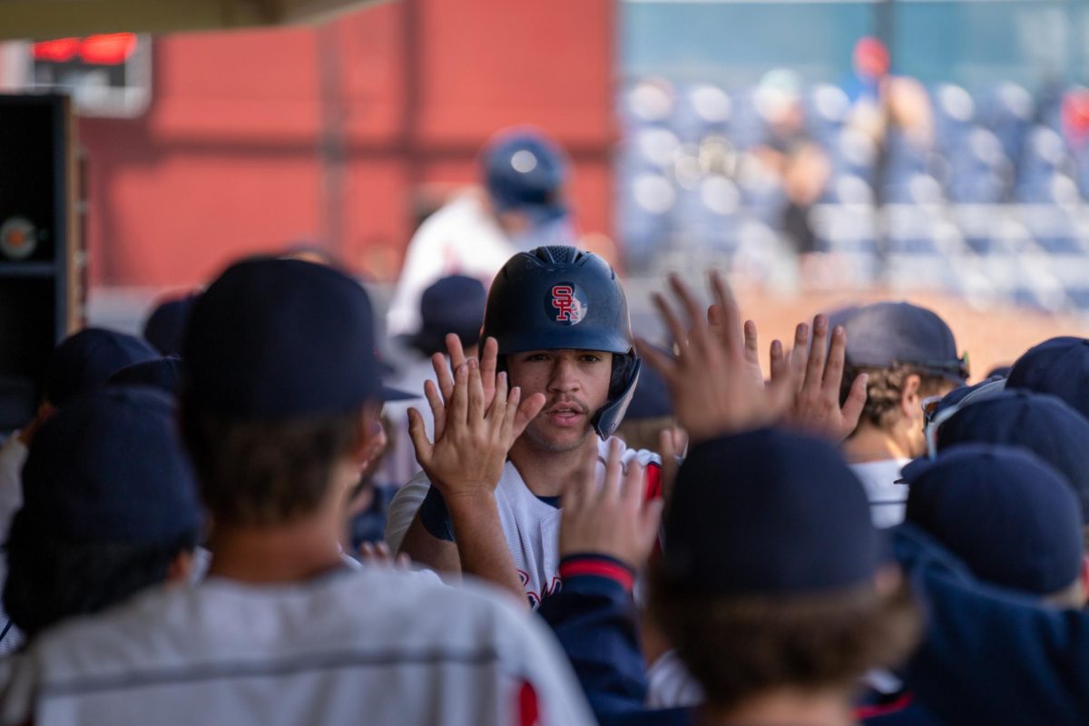 Santa Rosa Junior College designated hitter JT Summers is greated with a flurry of high-fives in the dugout after being knocked in by second baseman Joe Brown against San Joaquin Delta on Tuesday, March 11, 2025 in Santa Rosa.