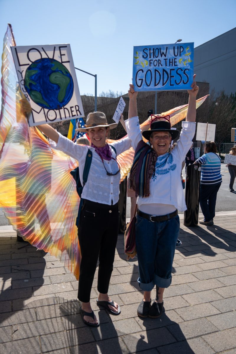Friends Valerie Seabag and Sarah Hylton dance with signs in support of the International Women’s Day march in Old Courthouse Square on Saturday, March 8, 2025 in Santa Rosa.  
