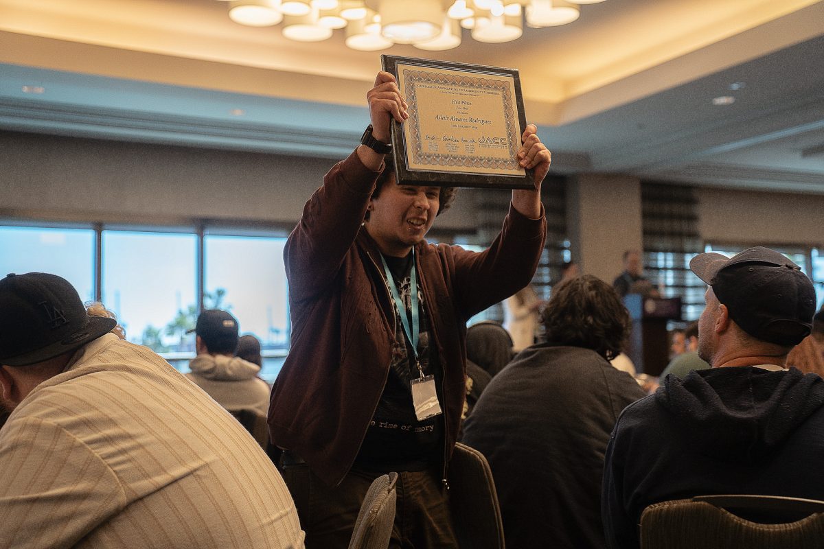 The Oak Leaf's photographer Adair Alvarez Rodriguez holds up his award in victory at the ACP Spring National Media Conference on Saturday, March 8, 2025 in Long Beach, California.