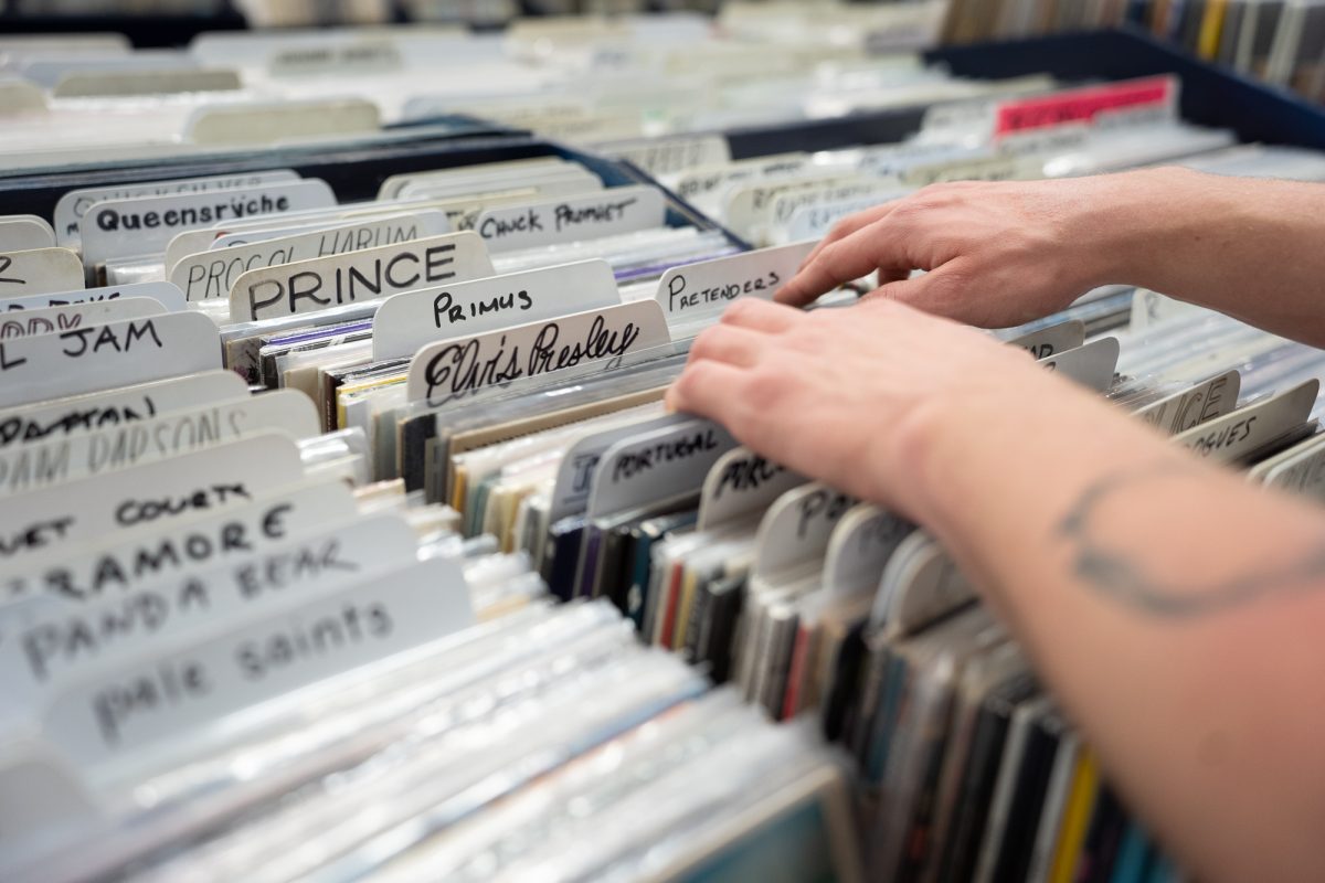 Lee Stumbaugh skims past the Elvis Presley records at The Last Record Store on Mendocino Boulevard on Saturday, March 1, 2025.