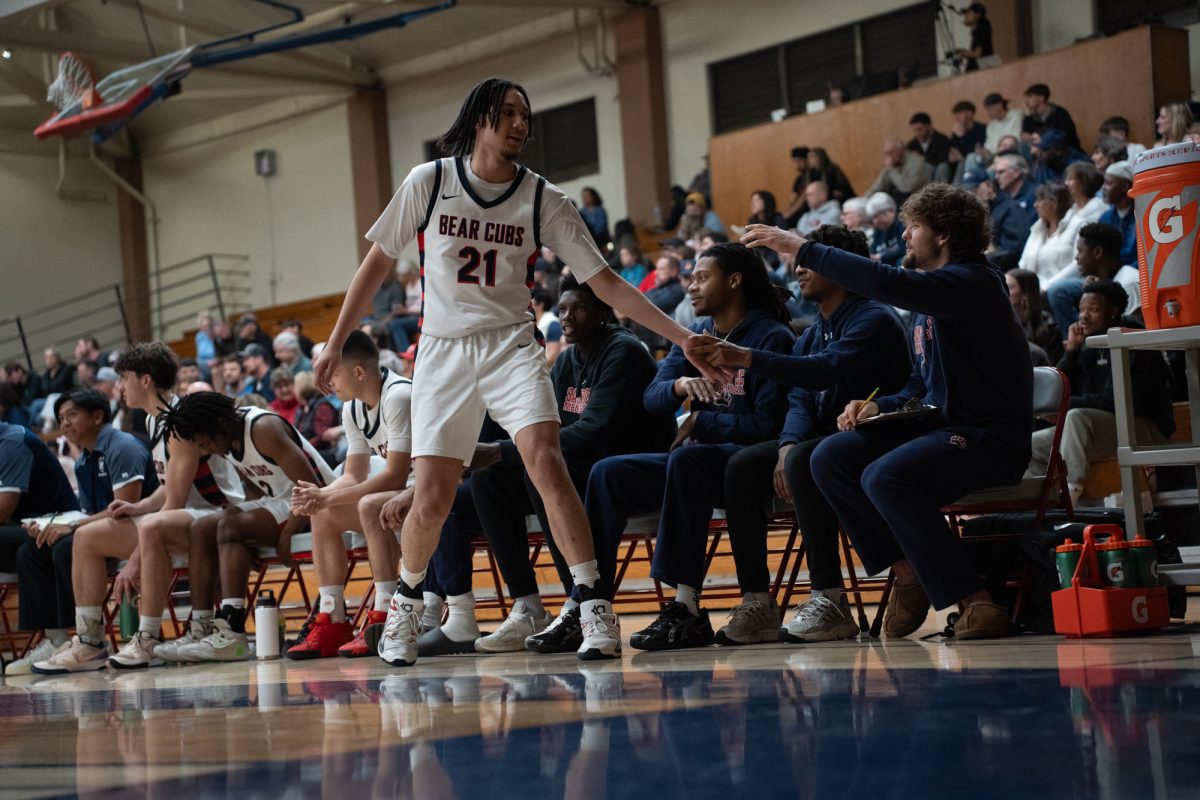 Bear Cubs forward Tayden Collins low-fives the bench after being swapped out during his match against Yuba College at Haehl Pavilion on Saturday, March 1, 2025.