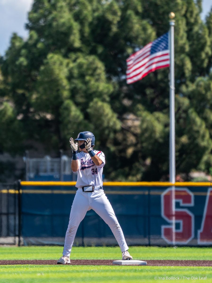 Designated hitter J.T. Summers slams his foot onto second base and claps his hands after a double to center field in the bottom of the first secures the first two RBIs of the day against Diablo Valley College on Thursday, April 3, 2025 in Santa Rosa.