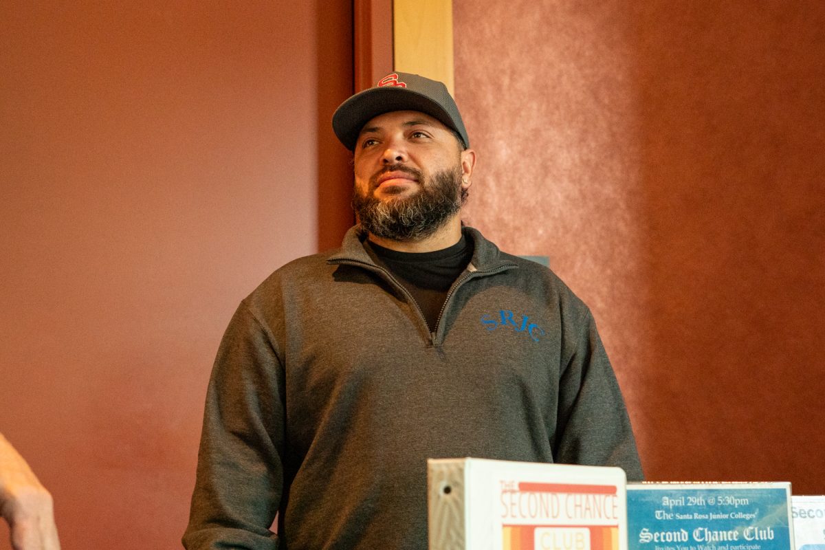 Santa Rosa Junior College's Second Chance Club's peer coach, Carlos DelPalacio welcomes guests warmly as they come in to view the pieces of art on display in Bertolini Hall on Tuesday, April 15, 2025 in Santa Rosa.
