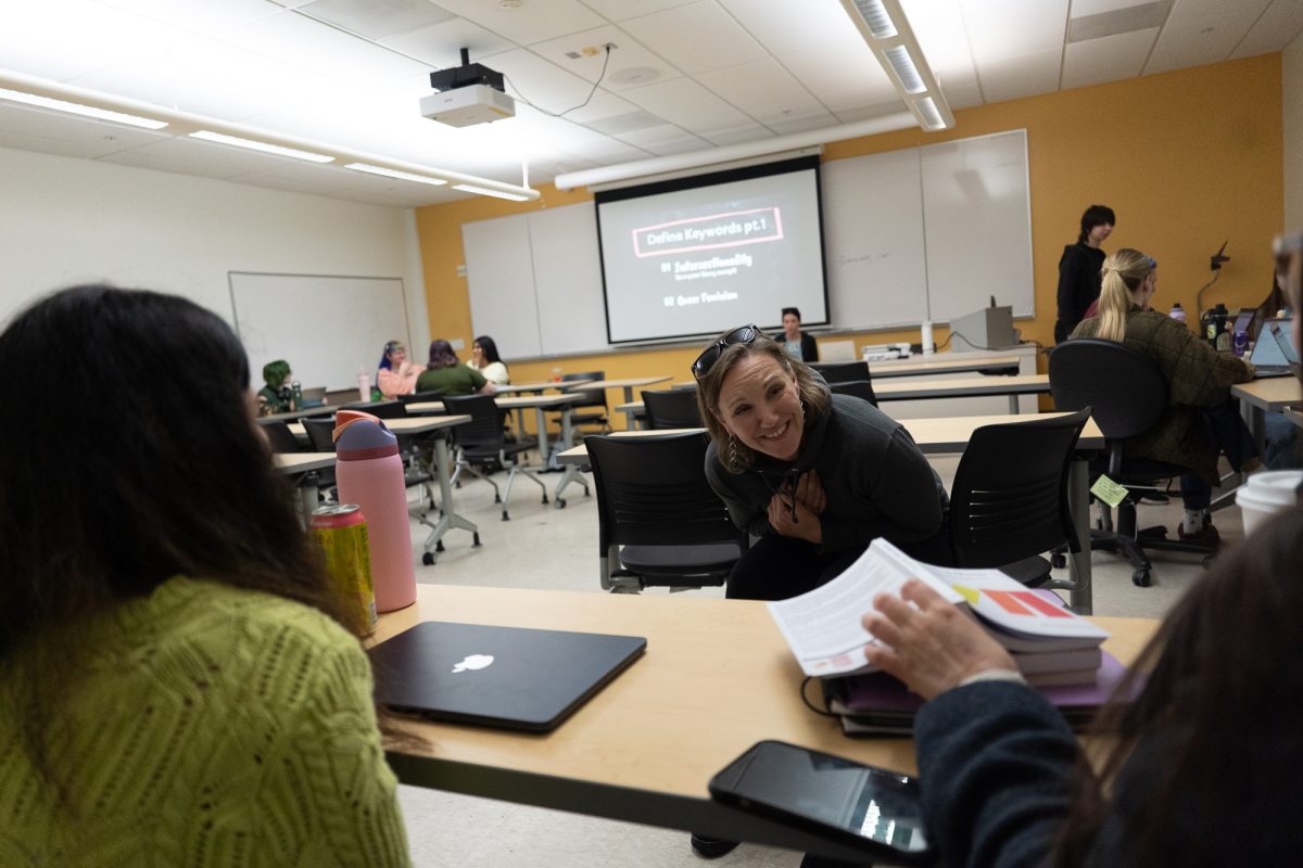 Janis Phillips shares a moment with her colleagues during a Women and Gender Studies class in 35 Darwin at Sonoma State University on April 2, 2025. Phillips' conversation comes after a presentation on the book Feminism is Queer by Mimi Marinucci.