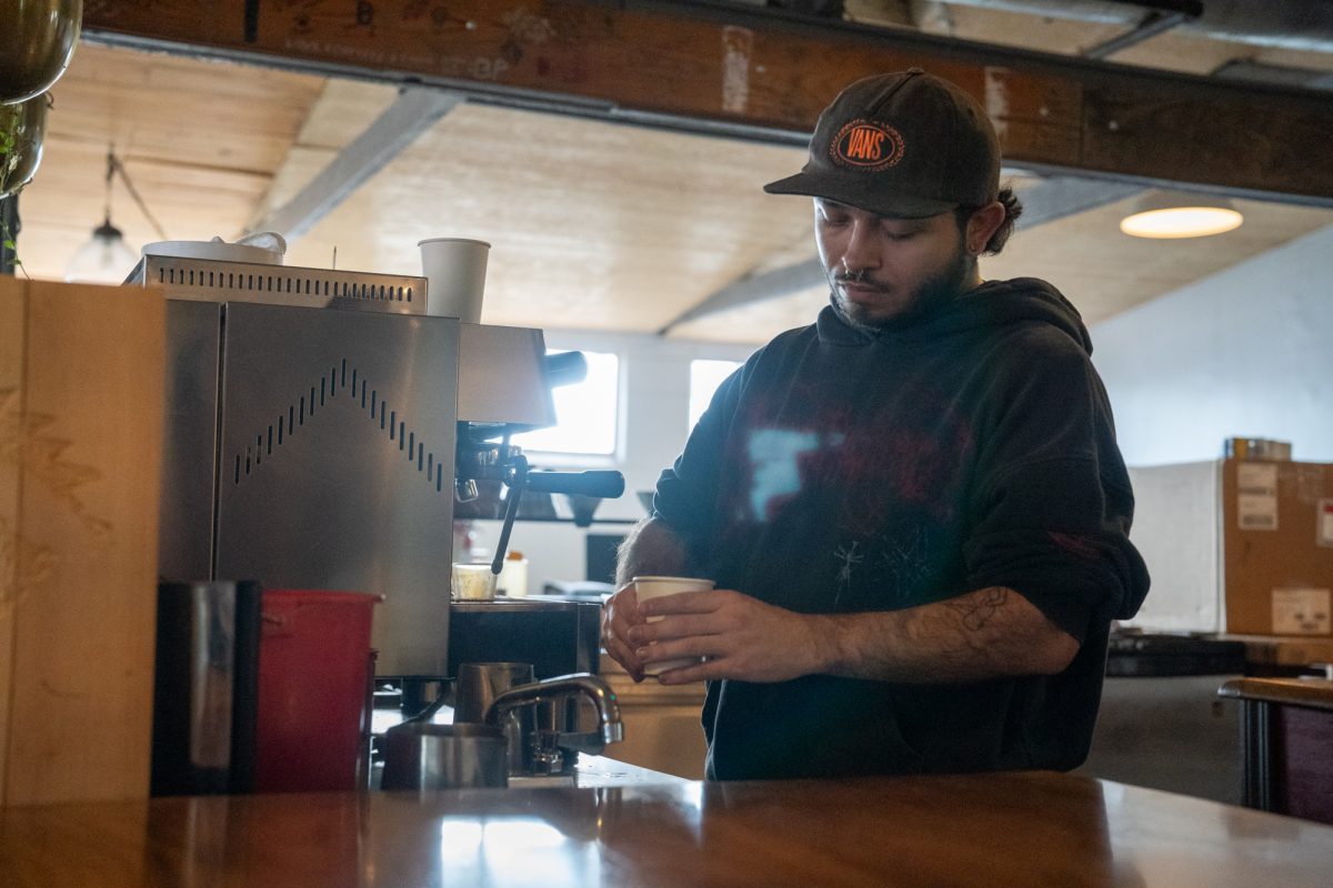 Petaluma Tea & Coffee barista Sebastian prepares a fresh latte with a charming design for a thirsty customer. The coffee shop is located on 212 2nd St. in Petaluma.
