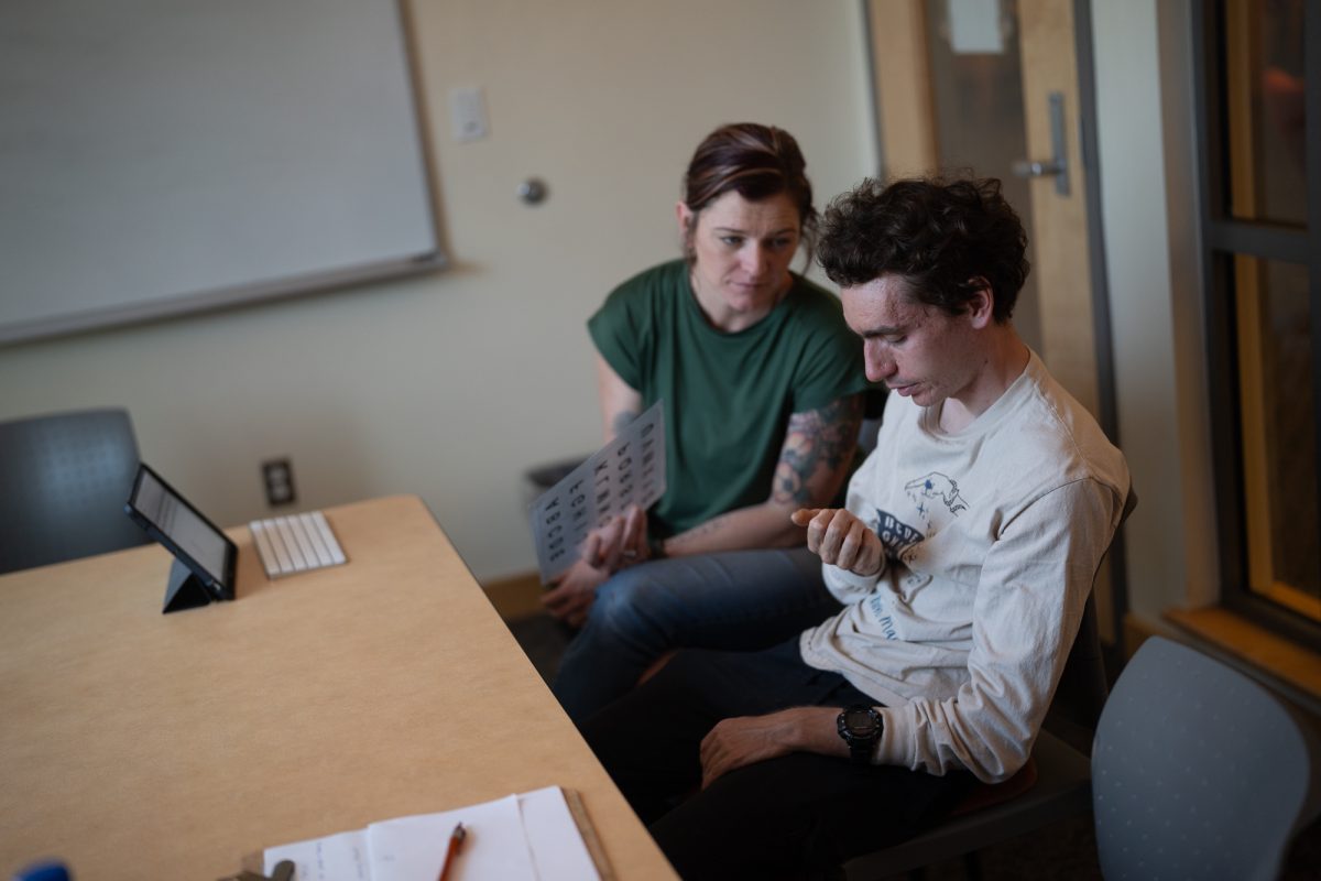 Masking autistic traits to fit into the neurotypical world can be taxing, creating more anxiety and stress in autistic individuals. Lindsey Goodrich, Augmentative and Alternative Communication specialist, helps Oak Leaf reporter, Noah McSweeney, through a tense moment in Doyle Library. 