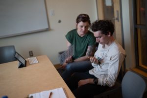 Masking autistic traits to fit into the neurotypical world can be taxing, creating more anxiety and stress in autistic individuals. Lindsey Goodrich, Augmentative and Alternative Communication specialist, helps Oak Leaf reporter, Noah McSweeney, through a tense moment in Doyle Library. 