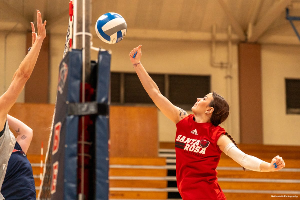 Bear Cubs's freshman Jillian Mefferd and former headcoach Kaitlin Ferguson reach for the ball during a fun showdown between the current team, and a team consisting of recent alumni on Friday, April 18, 2025 at Haehl Pavilion.