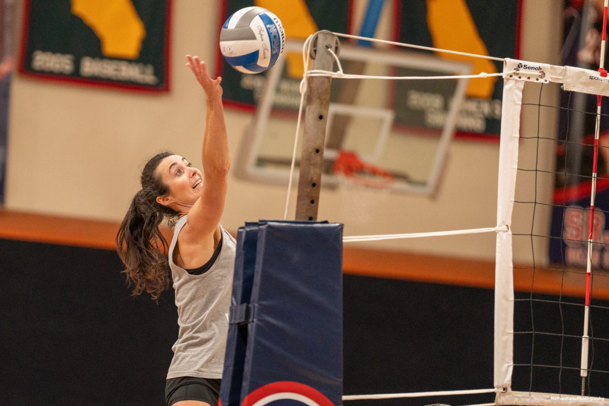 Santa Rosa Junior College's former volleyball headcoach Kaitlin Ferguson reaches up for a spike during the alumni night festivities on Friday, April 18, 2025 at Haehl Pavilion.