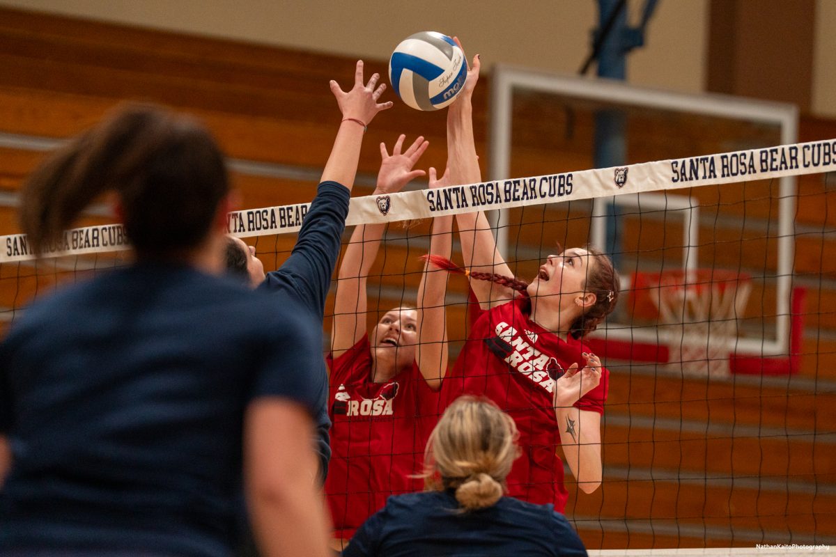 Santa Rosa Junior College's Haylen Guynup and Eve Mendoza makes contact on a block against a team consisting of the oldest alumni class on the night on Friday, April 18, 2025 at Haehl Pavilion.