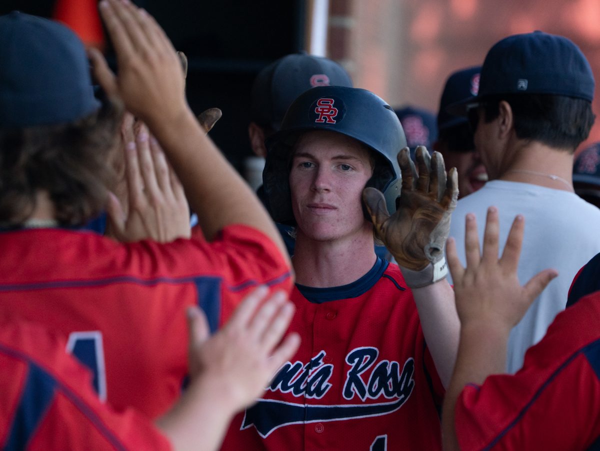 Freshman Ayden Herrguth walks down a dugout of high fives as he scores the first run against American River in the bottom of the third during the first game of the 3C2A Baseball Regionals against American River College on Friday, May 2, 2025 at home. 