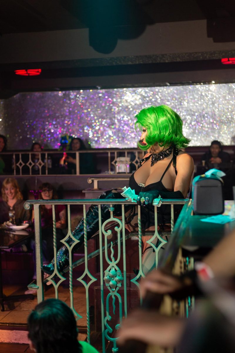 Roxy DelValle seductively traverses the room while carrying a heavy burden, during a performance at Hamburger Mary's in Long Beach, California on March 7, 2025.