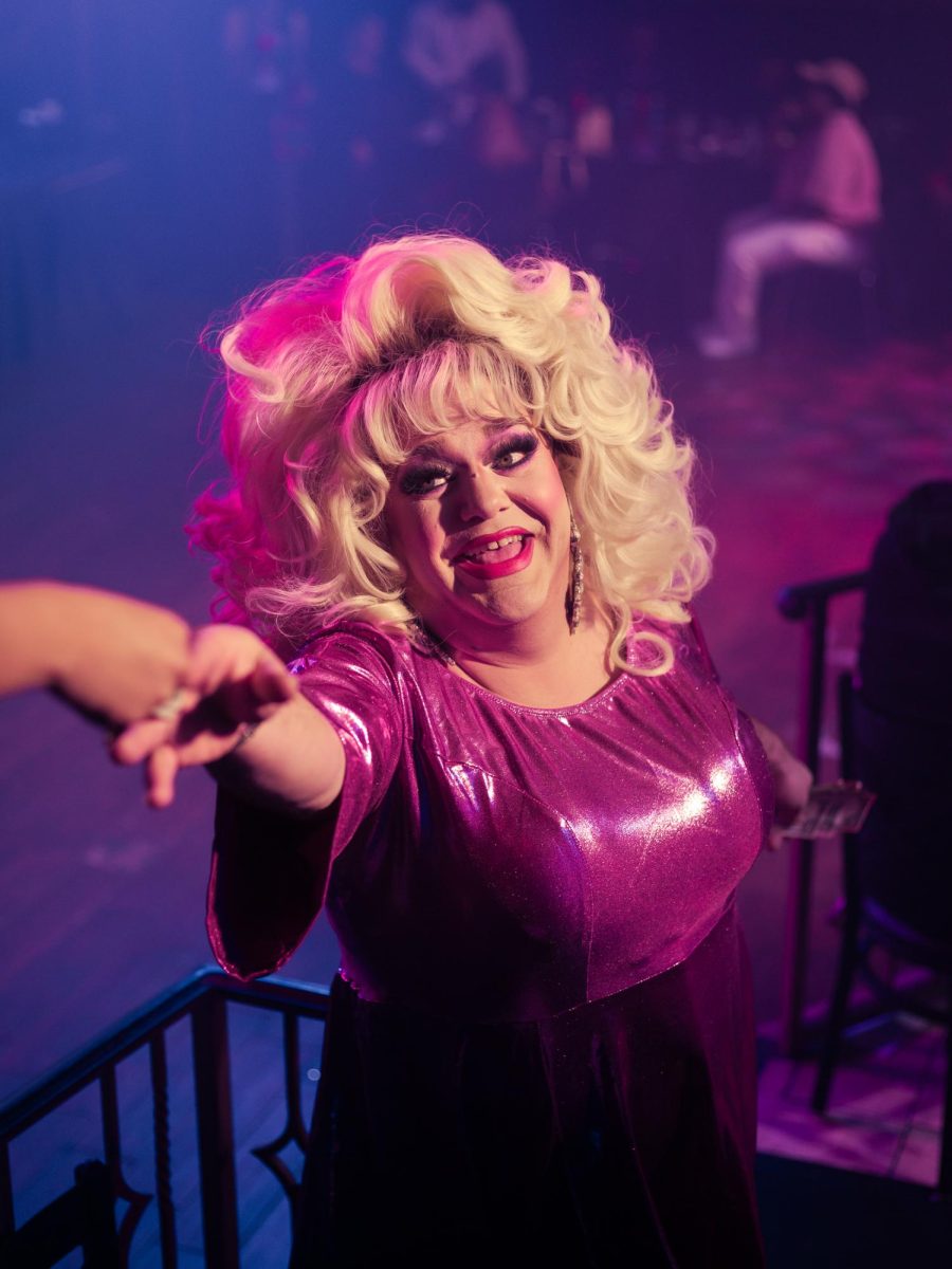 Jewels extends their arm for a tip during their performance at Hamburger Mary’s in Long Beach, California on March 7, 2025.