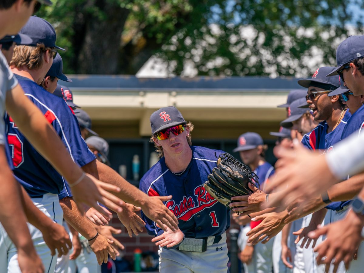 Freshman starting right fielder Ayden Herrguth runs down the line of high fives during lineup before going against Sierra in game three of the 3C2A Regional Finals on Sunday, May 18, 2025 in Santa Rosa.