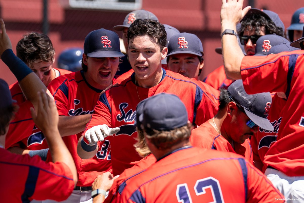 Santa Rosa Junior College's designated hitter, J.T. Summers returns to the dugout, surrounded by elated teammates after hitting a home-run in the top of the fourth inning during game four of the 3C2A Super Regionals on Saturday, May 10, 2025 in Santa Rosa.