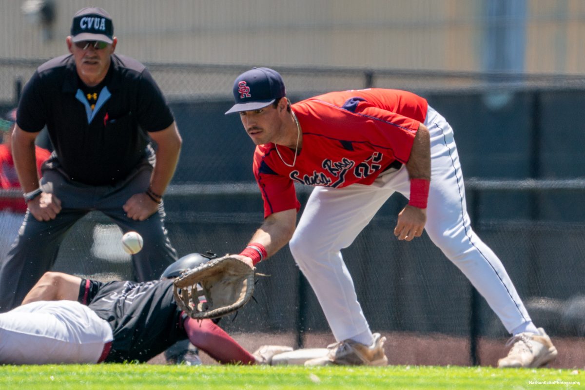 Santa Rosa Junior College's sophomore first baseman Josh Martin prepares to catch the ball as Sierra's baserunner dives back during game two of the 3C2A Regional Finals on Saturday, May 17, 2025 in Santa Rosa. 