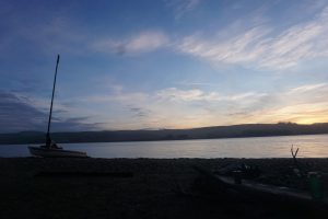 Henry Fliflet's boat docks along a beach on Tomales Bay as the sun sets on a long day.