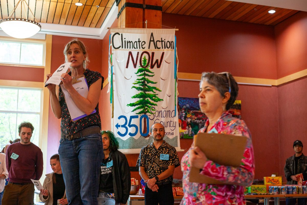 High school teacher and event founder Sunny Galbraith briefs participating students on their role before Bertolini Hall's doors open for Climate Action Night on April 24.