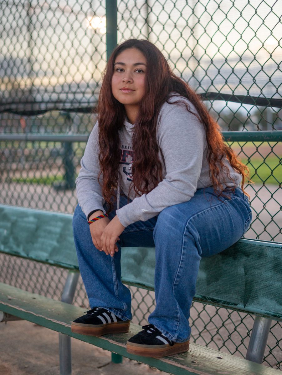 Gabby Schenone peers out of the dugout of Magnolia Park on Jan. 28 in Rohnert Park, California.
