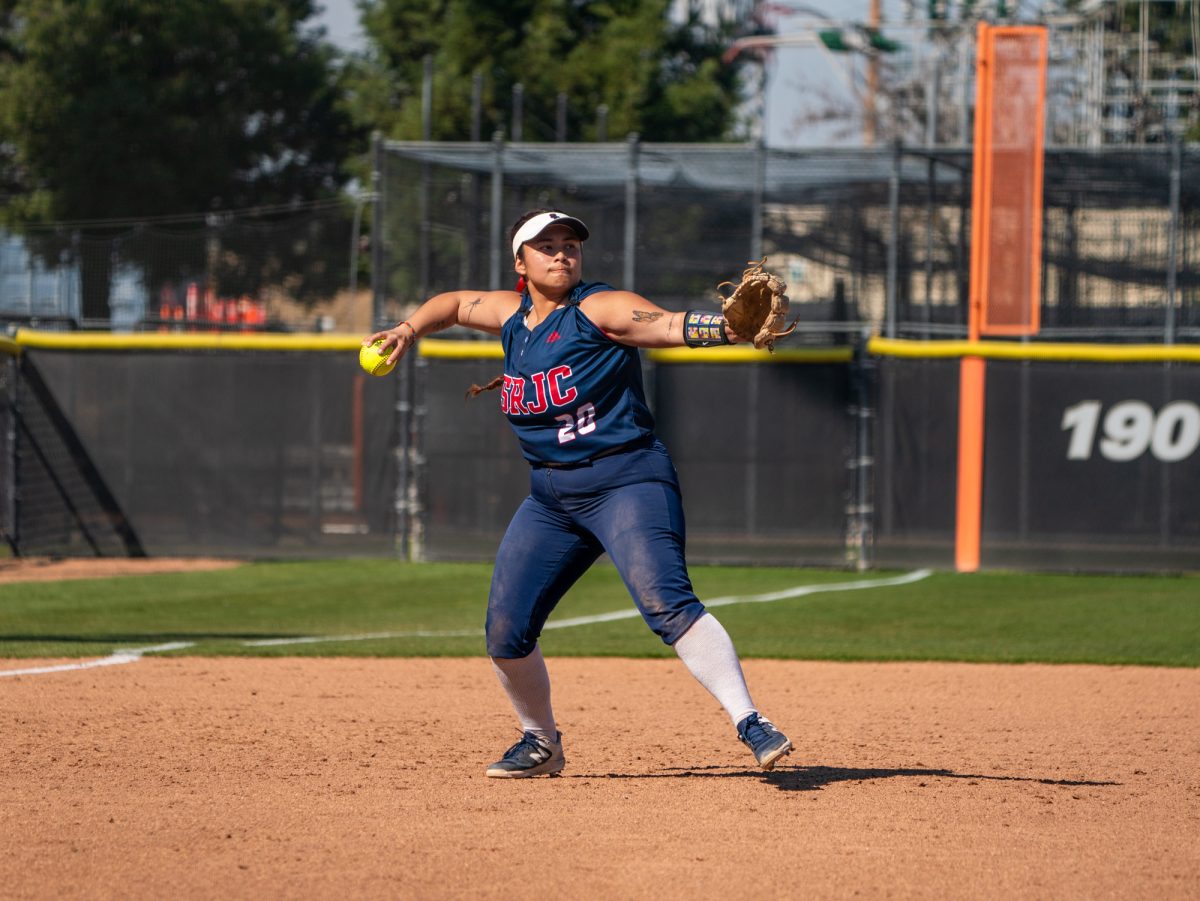 Sophomore third baseman Gabby Schenone launches the ball towards first base during the game against San Joaquin Delta on the Bill Simoni softball field on Feb. 22 in Stockton, California.