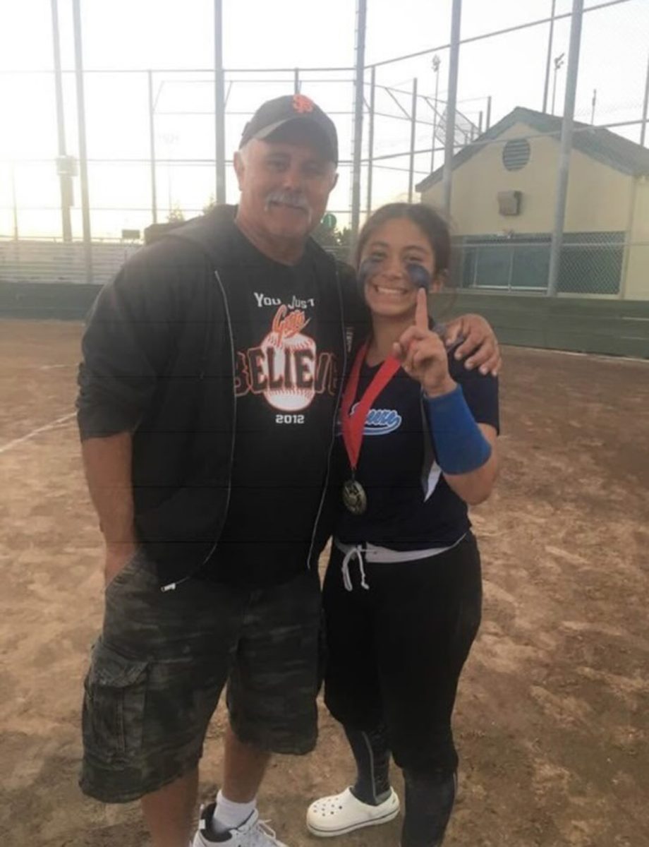 Gabby Schenone, right, poses with her Papa Joe, left, after a travel ball tournament with the Petaluma Steel Breeze in 2019.