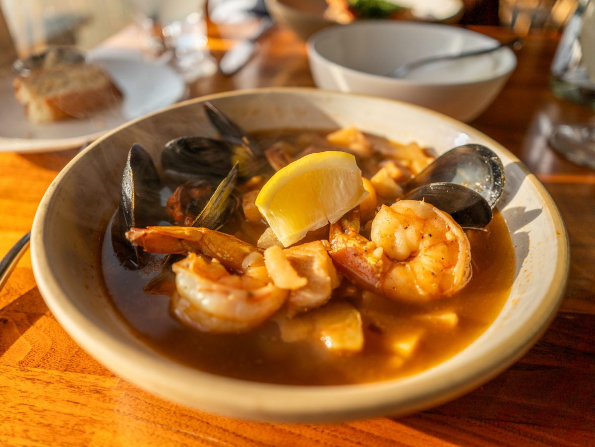 The seafood stew on the dinner menu features tail-on shrimp, black cod, mussels, fennel, onion, fingerling potatoes, parsnip and paprika at Coast Kitchen on March 18, 2025 in Jenner, California.