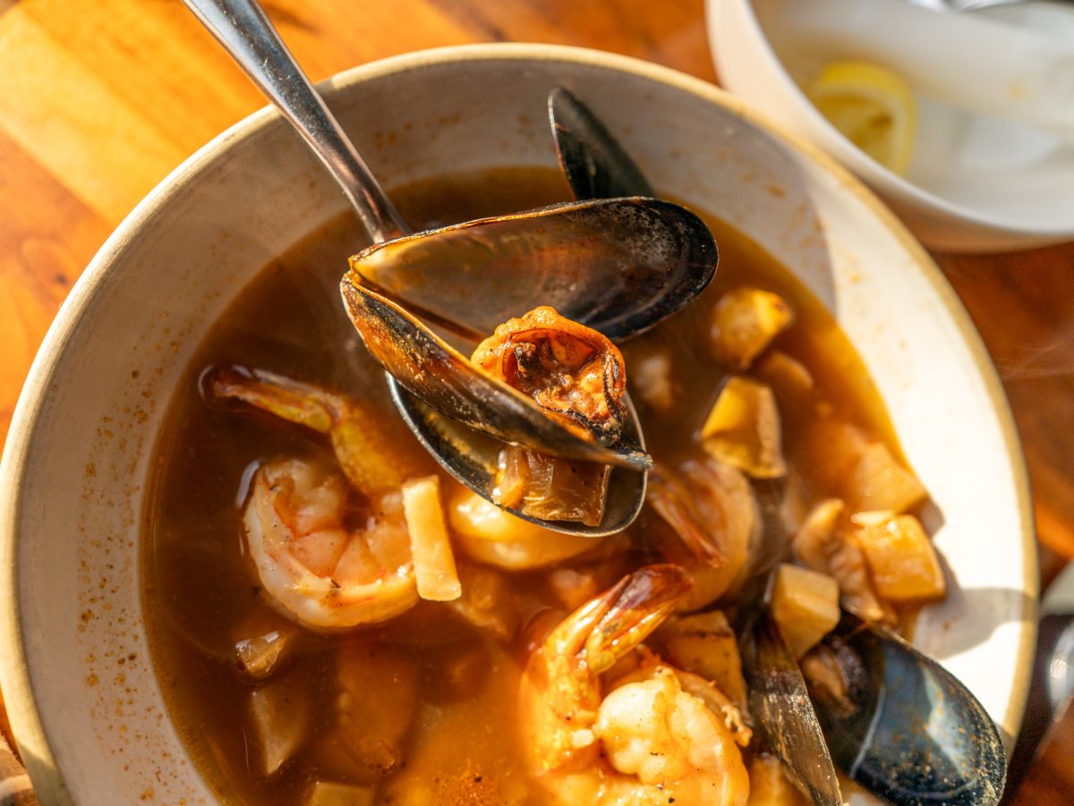 Whole shell mussels, shrimp and cod are featured in the seafood stew at Coast Kitchen on March 18, 2025 in Jenner, California.