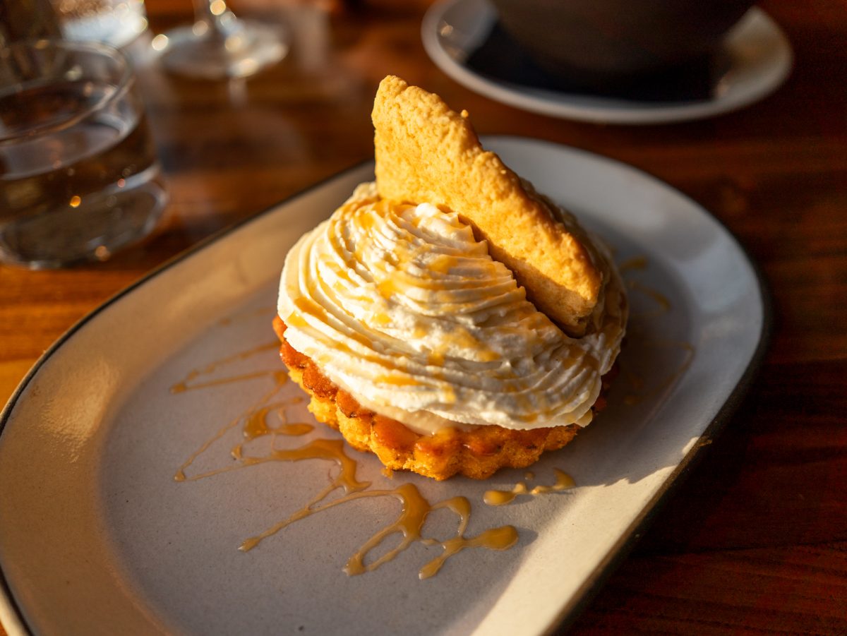 The coconut cream pie is drizzled with caramel and topped with a flaky cookie resembling its crust at Coast Kitchen on March 18, 2025 in Jenner, California.