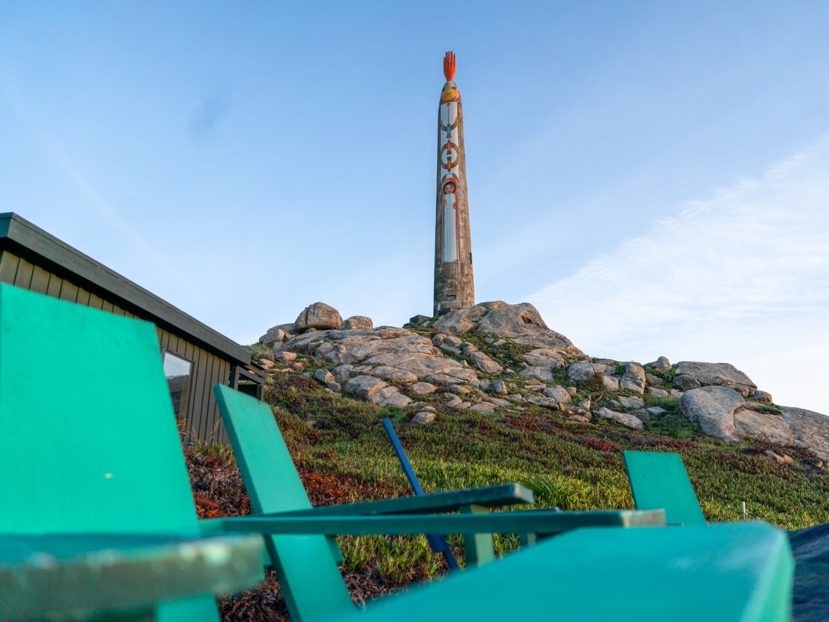 Timber Cove Resort offers outdoor seating by a fireplace right outside of the patio doors of Coast Kitchen. A totem pole towers over the hotel and restaurant and marks the hotel's place on the coast. The pole on the property can be seen in small bouts as patrons make their way up the highway towards the resort.