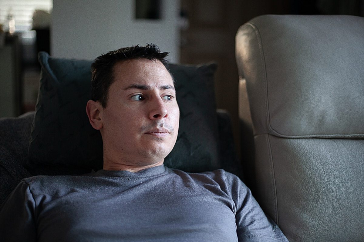 Disabled Air Force veteran Anthony Clark gazes out of the window from the recliner to which most of his life is restricted. 