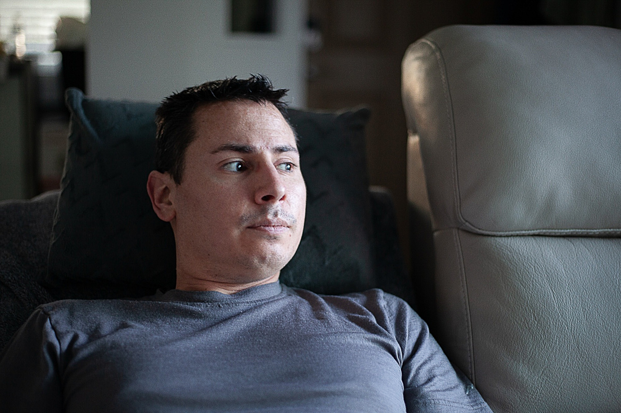 Disabled Air Force veteran Anthony Clark gazes out of the window from the recliner to which most of his life is restricted.