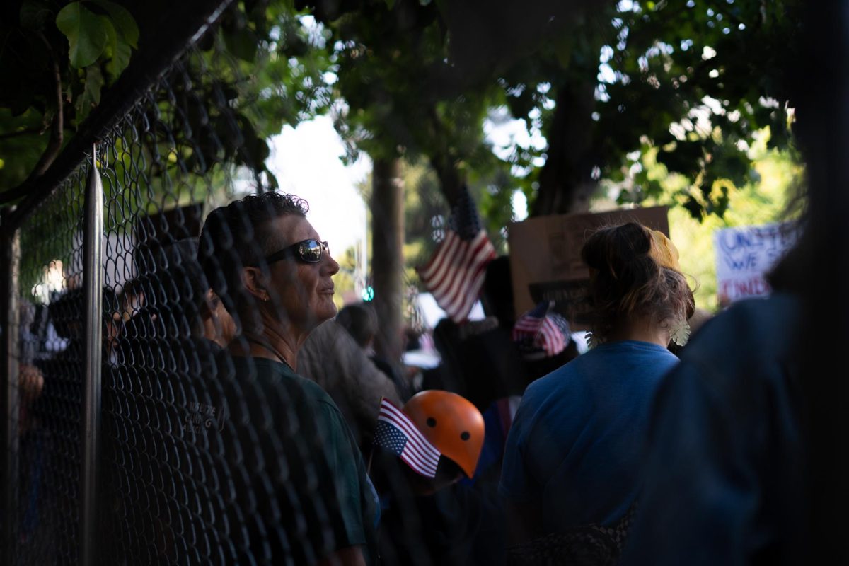 A protestor watches as the crowd circles around downtown Santa Rosa on Wednesday, June 11, 2025. After an hour of assembling, the crowd went from approximately 30 people to at least 200.