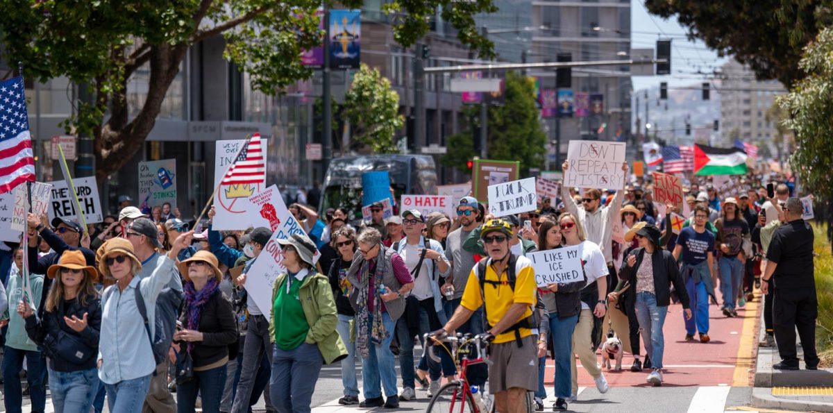 Protesters march on Mission Street from Dolores Park to Civic Center Plaza for "No Kings Day" on Saturday, June 14, 2025 in San Francisco.